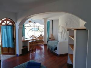 a bedroom with a bed and a dining room with a table at Suites Sultan in Copacabana