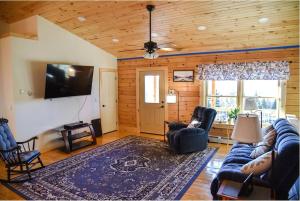 a living room with a blue couch and a tv at Mountain Views! Copper Cannon Lodge in Franconia in Franconia