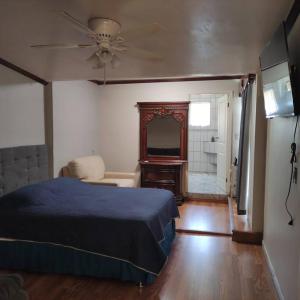 a bedroom with a bed and a dresser and a mirror at BEAUTIFUL AND COZY WITH TERRACE, GREAT LOCATION in Mexicali