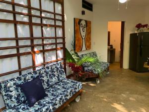 a living room with a couch and a chair at Peaceful Jungle Villa Kona - Pool & Parking for 2 persons in Puerto Viejo