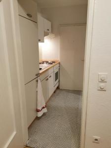 a small kitchen with a sink and a stove at Privatwohnung im Stadtzentrum in Gießen +2 photos