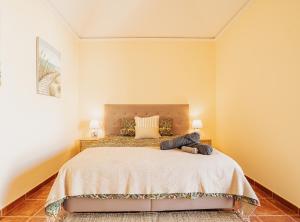 a bedroom with a large bed and two lamps at La Tejita Ocean Villa in Granadilla de Abona