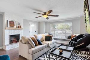 a living room with a couch and a ceiling fan at Desert Oasis Family Retreat Old Town Scottsdale in Scottsdale