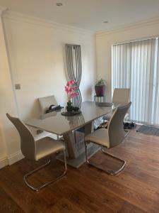 a dining room with a table with chairs and a desk at Double Room in a cosy house in Pitsea in Pitsea