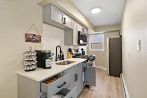 a kitchen with a sink and a stove at 2BR Midway Getaway! l 20 min to downtown Chicago in Stickney