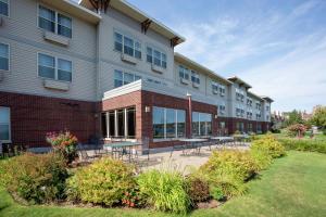 a building with tables and chairs outside of it at Hampton Inn Duluth-Canal Park in Duluth