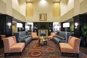 a lobby with couches and chairs and a fireplace at Hampton Inn & Suites Effingham in Effingham