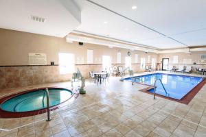 a pool in a large room with tables and chairs at Hampton Inn & Suites Effingham in Effingham