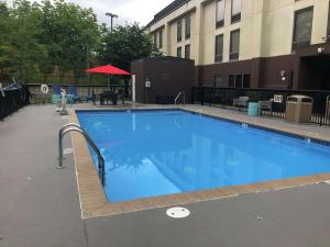 a large blue swimming pool next to a building at Hampton Inn El Dorado in El Dorado