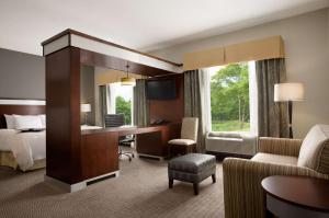 a hotel room with a bed and a desk at Hampton Inn & Suites - Mansfield in Mansfield