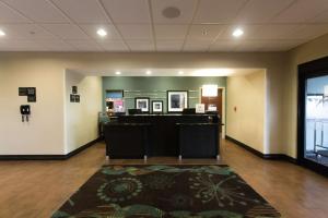 an empty lobby with a waiting room with a desk at Hampton Inn & Suites Middlebury in Middlebury +35 photos