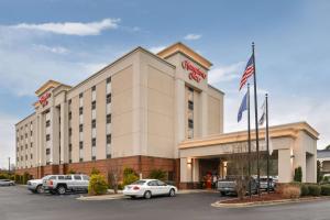 a hotel with cars parked in a parking lot at Hampton Inn Emporia in Emporia