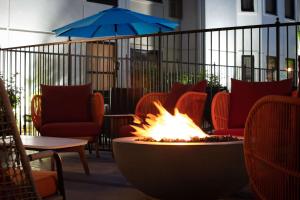 a fire pit in the middle of a room with chairs at Hampton Inn & Suites El Paso-Airport in El Paso