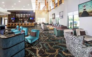 a hotel lobby with a zebra patterned carpet at Embassy Suites by Hilton Fayetteville Fort Bragg in Fayetteville