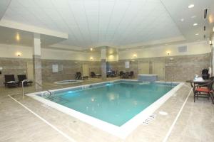 a large swimming pool in a hotel lobby at Embassy Suites by Hilton Fayetteville Fort Bragg in Fayetteville