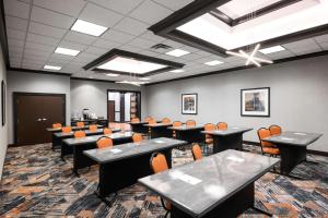 a conference room with tables and chairs in a room at Hampton Inn Evansville Airport in Evansville