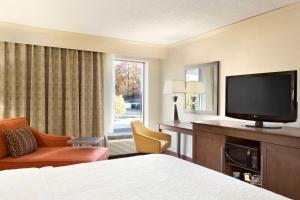 Habitación de hotel con cama y TV de pantalla plana. en Hampton Inn Forrest City, en Forrest City