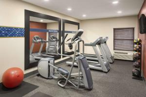 a gym with several tread machines and a mirror at Hampton Inn Findlay in Findlay