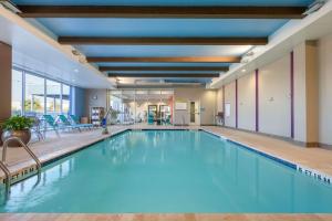 a large swimming pool in a hotel room at Home2Suites by Hilton Florence in Florence