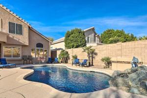 a swimming pool in front of a house at Swim-Putt-Play! 5-BR Family Wonderland w/ Parking in Phoenix