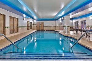 a swimming pool with blue lights in a hotel at Hampton Inn and Suites Flint/Grand Blanc in Flint