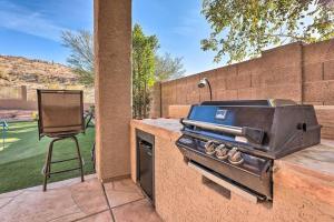 a grill on a counter with a chair on a patio at Swim-Putt-Play! 5-BR Family Wonderland w/ Parking in Phoenix