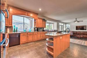 a large kitchen with wooden cabinets and a counter top at Swim-Putt-Play! 5-BR Family Wonderland w/ Parking in Phoenix