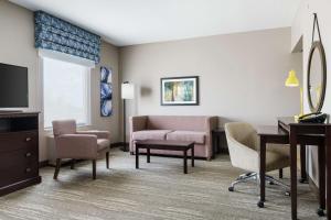 a living room with a couch and a desk at Hampton Inn & Suites Ft. Lauderdale/West-Sawgrass/Tamarac, FL in Tamarac