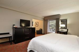 a hotel room with a bed and a flat screen tv at Hampton Inn Stafford / Quantico-Aquia in Stafford