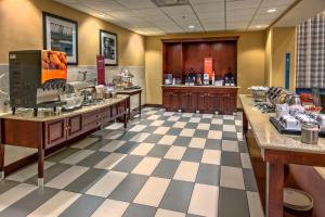 a lobby with a cafeteria with a buffetasteryasteryasteryasteryasteryasteryasteryastery at Hampton Inn & Suites Fort Myers Estero in Estero