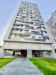 a tall building with a green lawn in front of it at Coruña House in A Coruña