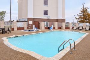 a large swimming pool in front of a building at Hampton Inn & Suites Greenville in Greenville