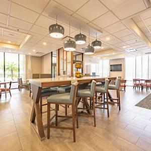 a kitchen and dining room with a table and chairs at Hampton Inn Gainesville in Gainesville