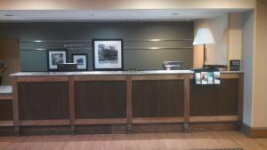 a lobby of a hotel with a reception counter at Hampton Inn Greenwood in Greenwood