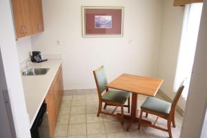 a kitchen with a table and chairs and a sink at Hampton Inn Greeneville in Greeneville