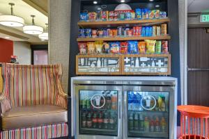 a drink cooler in a restaurant with a chair at Hampton Inn Greenwood in Greenwood