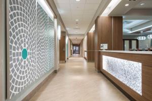 a hallway in a hospital with a tile wall at Hampton Inn Greenville/I-385 Haywood Mall, SC in Greenville