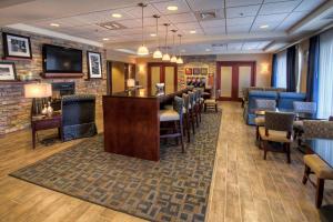 a waiting room with chairs and a bar at Hampton Inn - Great Falls in Great Falls
