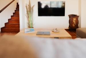 a living room with a table with a laptop on it at La Tejita Ocean Villa in Granadilla de Abona +29 photos