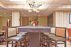 a conference room with a large table and chairs at Hampton Inn Huntington/Barboursville in Barboursville