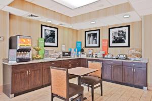 um restaurante com uma mesa e cadeiras num quarto em Hampton Inn Huntington/Barboursville em Barboursville