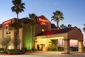 a hotel with neon signs on the front of it at Hampton Inn Houston Northwest in Houston