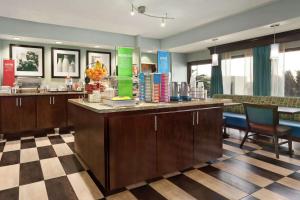 a lobby with a cafeteria with a counter and chairs at Hampton Inn Houston Northwest in Houston