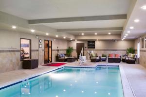 a pool in a hotel room with a living room at Hampton Inn Harrisonburg South in Harrisonburg
