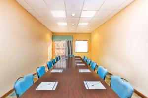 a conference room with a long table and blue chairs at Hampton Inn Huntsville-Arsenal/South Parkway in Huntsville