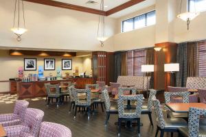 a restaurant with tables and chairs and a counter at Hampton Inn and Suites Indianapolis-Fishers in Fishers