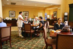 um grupo de pessoas sentadas em torno de uma mesa em um restaurante em Hampton Inn & Suites Dobson em Dobson