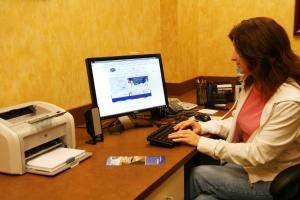 a woman sitting at a desk with a computer at Hampton Inn & Suites Dobson in Dobson