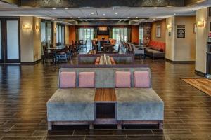 a lobby with chairs and tables in a building at Hampton Inn Indianapolis-SW-Plainfield in Plainfield