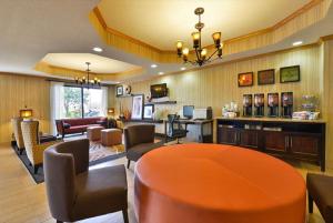 a lobby with a waiting room with a table and chairs at Hampton Inn Sturgis in Sturgis